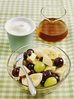 Fruit salad and greek yoghurt served with honey