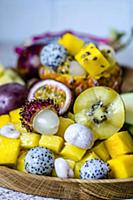 Exotic fruits on a wooden tray