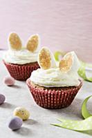 Two Easter bunny cupcakes with marshmallow ears in