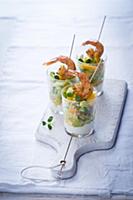 Orange and vegetables salad with prawns in glasses