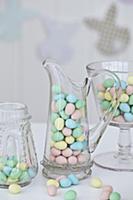 Jars of chocolate Easter egg candy on a table with