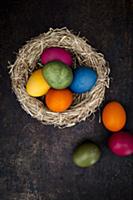 Easter eggs coloured with natural dyes in a nest