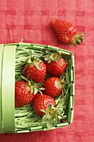 Fresh strawberries in a green plastic basket