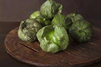 Fresh tomatillos on a wooden plate