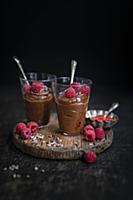 Two glasses of vegan chocolate mousse decorated wi