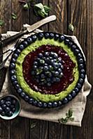 Spinach tart with raspberry jam, blueberries and m