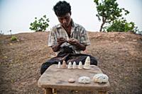 Myanmar / Mrauk U / 2014 / Boy is making stone fig