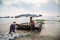 Myanmar / Ngapali / 2014 / Young Burmese sliding a
