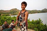 Myanmar / Mrauk U / 2014 / Boy playing guitar in f