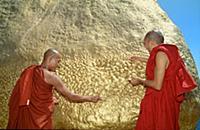 MYANMAR / Mon State / Monks donating gold leaf on 