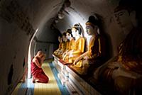 MYANMAR / Mon State / Bago / Young monk praying in