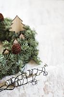 Wreath decorated with wooden Christmas trees next 