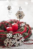 Wreath decorated with wooden snowflakes and red co